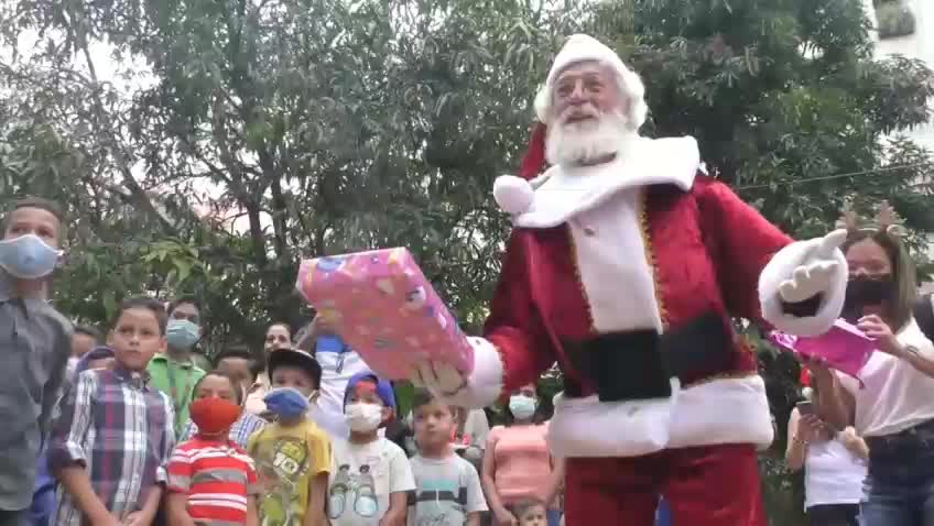 Santa spreads festive cheer, trading his sleigh for a red motorcycle in Venezuela's capital Caracas