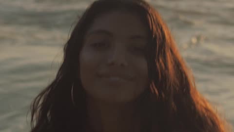 womans portrait wearing a bikini at the beach