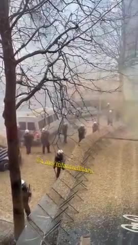 Brussels police teargas farmers. Farmers reply by spraying them with straw
