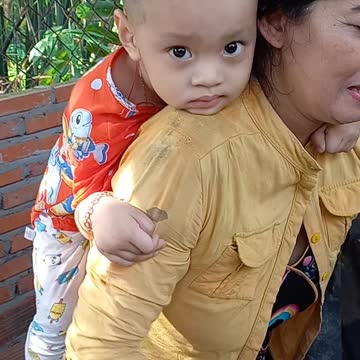 grandma port baby on her back