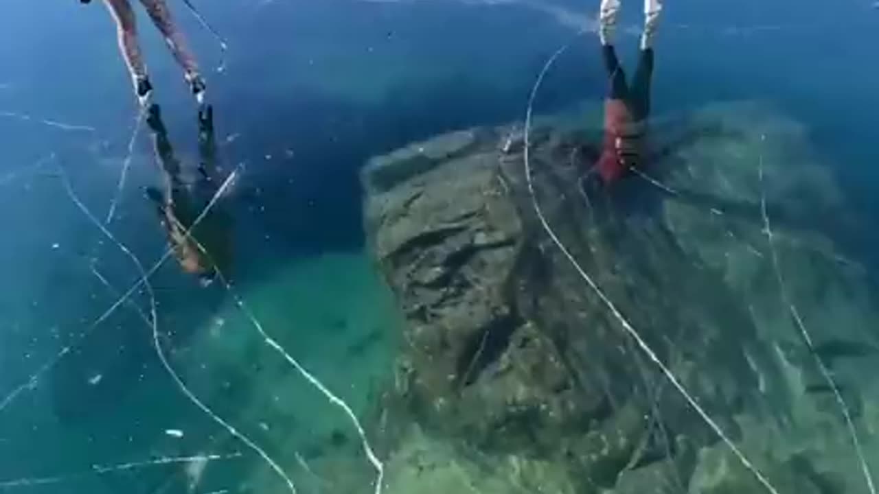 Skating over the clear glassy ice of rabbit lake in Canada