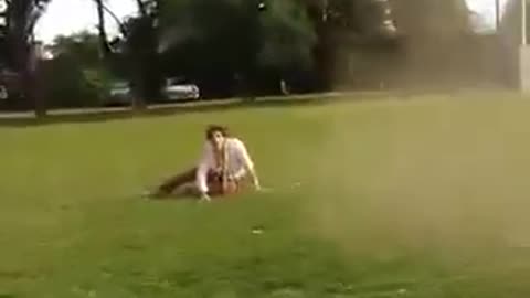 Guy on top of car while car is moving falls