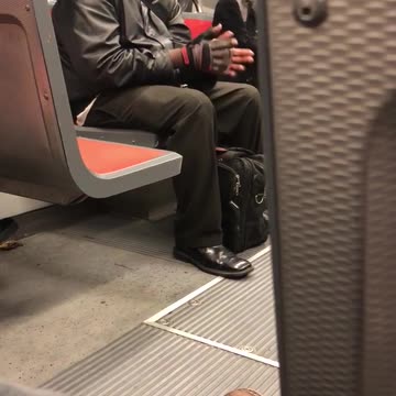 Man in leather jacket black glasses laughs by himself