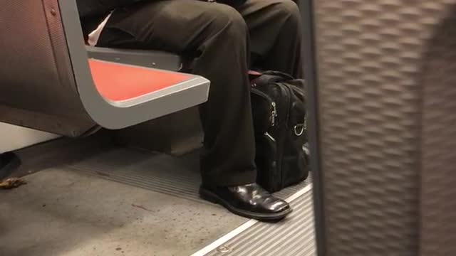 Man in leather jacket black glasses laughs by himself