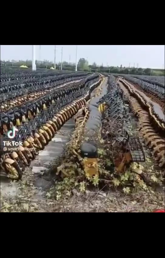 A graveyard of electric green scooters that have run out of battery life