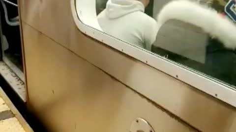 Man black jacket practicing martial arts on train