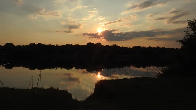 Nice Time Lapse Video of a Guy Fishing in the River at Sunset