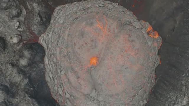 Drone footage shows huge blocks of red, hot lava rolling down