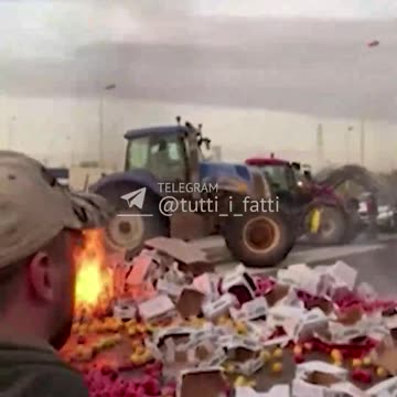 French farmers overturn and set fire to a truck loaded with peppers