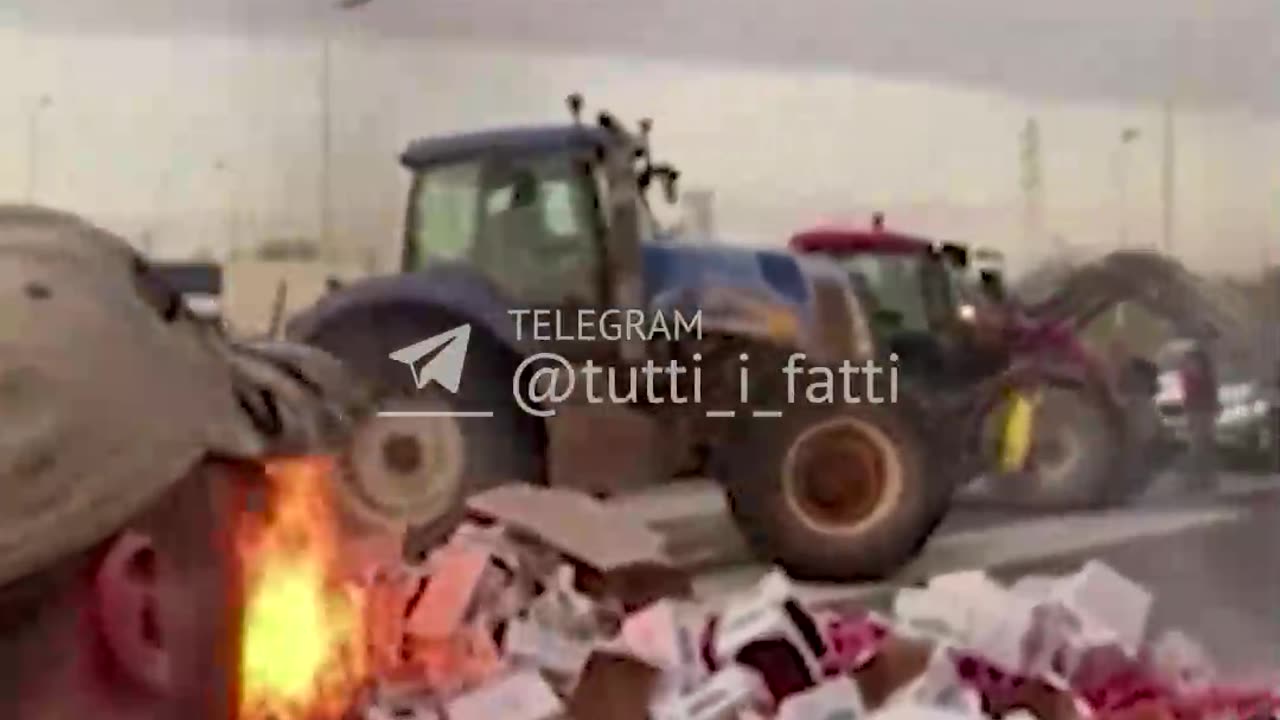 French farmers overturn and set fire to a truck loaded with peppers