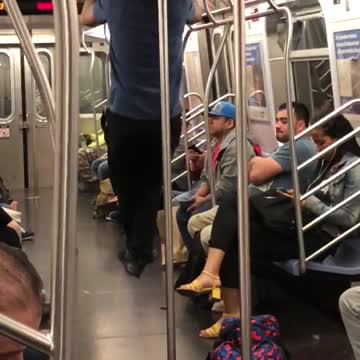 Guy blue shirt black pants doing pull ups in subway
