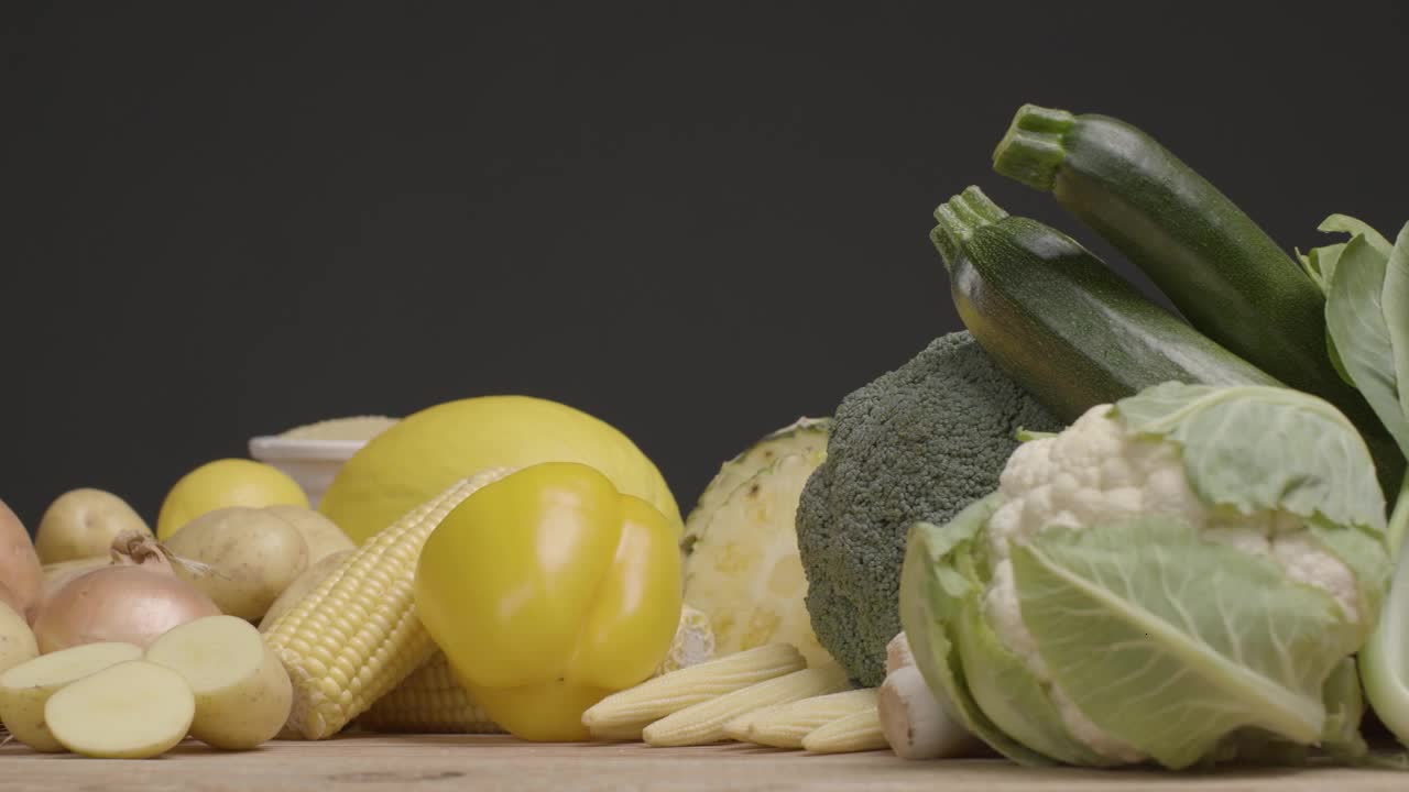 Sliding Shot Along Rustic Wood Table of Fruit and Vegetables 09