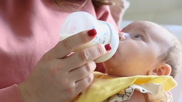 A mother is Breastfeeding Her baby With Relexing music