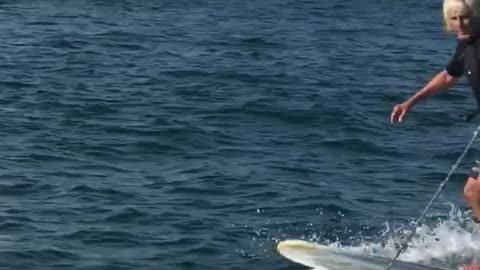 Blonde guy black shirt wakeboard paddlde board