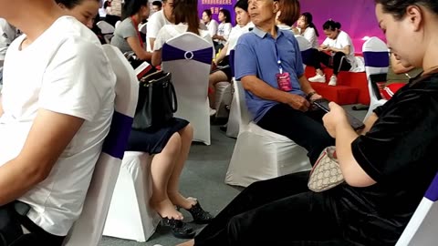 Mature Chinese lady at a trade show...