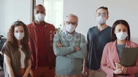 Diverse Business Team in Face Masks Posing for Camera in Office