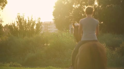 Two girls ride horses