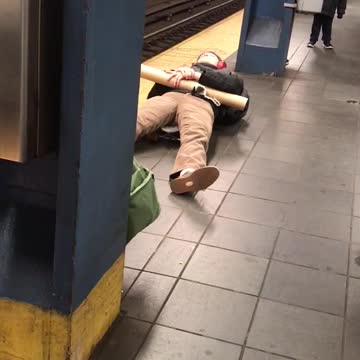 Man with red headphones laying down with poster