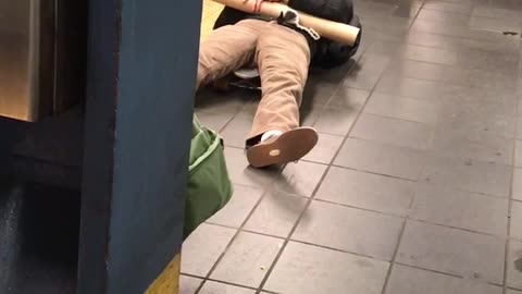 Man with red headphones laying down with poster