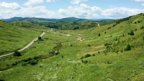 Cinematic aerial view of countryside meadow