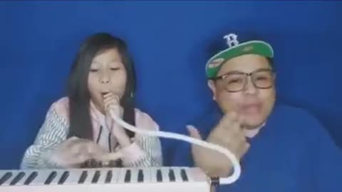 Girl plays instrument with her nose.