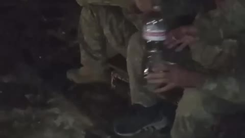 Russian soldier shares cigarettes with Ukrainian POWs.