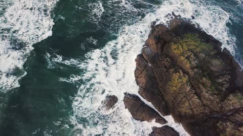 Waves Crashing On A Big Rock Formation