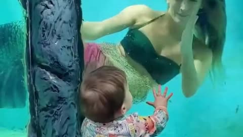 Amazing mermaid with kiss baby