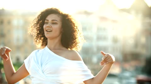 Girl dancing on a sunny afternoon, close up