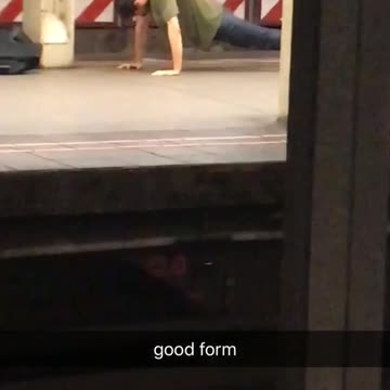 Good form man in green fast push ups in subway station