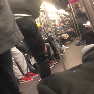 Subway performers swing on handrails and dance
