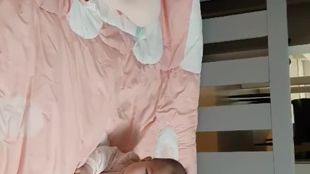 4 months old baby laughing while talking with her mother