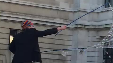 The man playing soap bubbles with children on the street