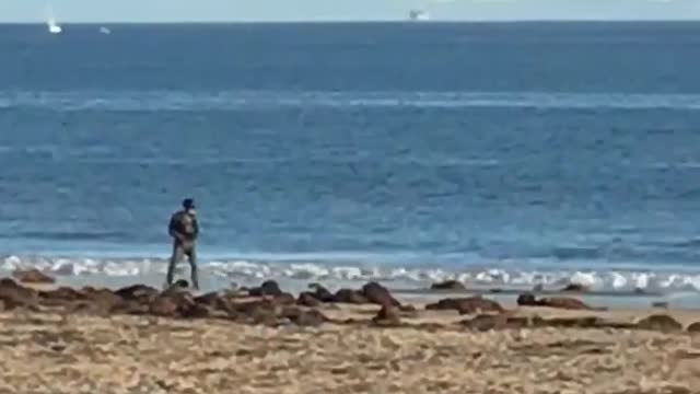 Man one wheel skateboard on beach