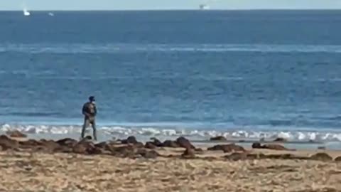 Man one wheel skateboard on beach