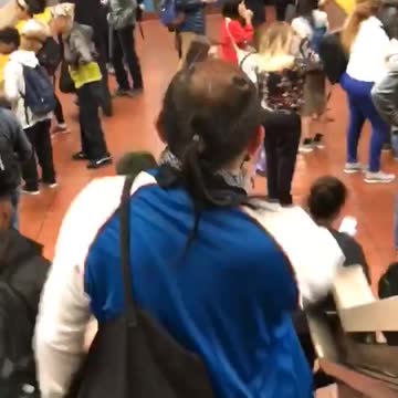 Man walking down subway station stairs little hair antennas