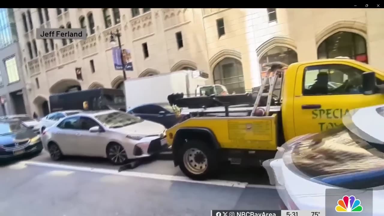 Tow truck tries to jack up a car in the middle of traffic