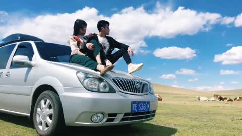 A couple posing on the grassland