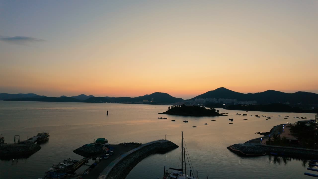 Sunset Casting a Warm Glow Over Mountain Range and Beach