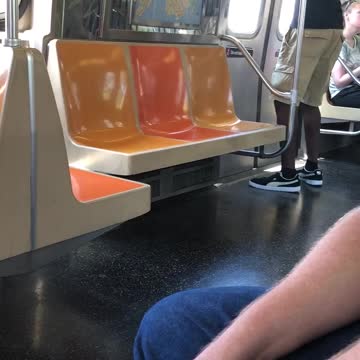 Guy subway dancing at door white shorts