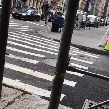 Guy grey shorts blue hat dancing spinning in streets