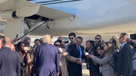 President Donald Trump lands in Michigan and takes questions from