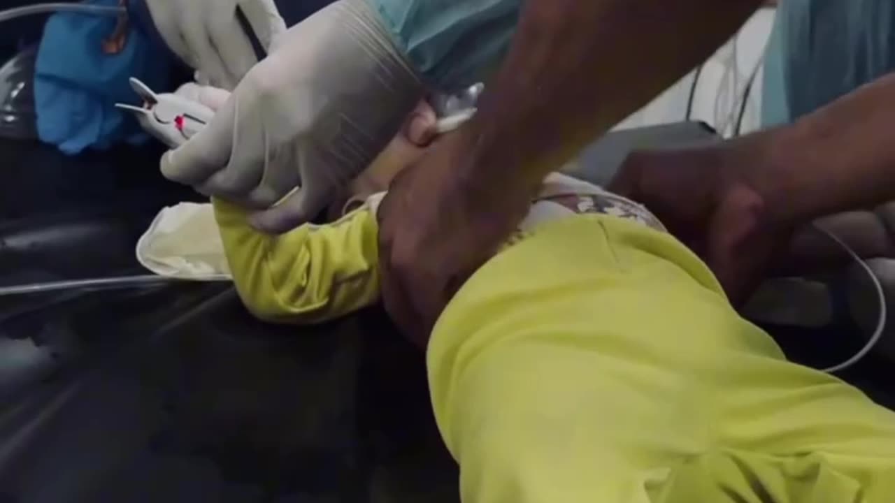 Medics desperately administering CPR in an attempt to save a child injured