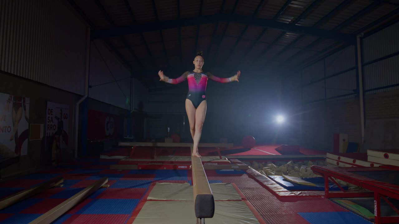 Talented gymnast practicing on a balance beam