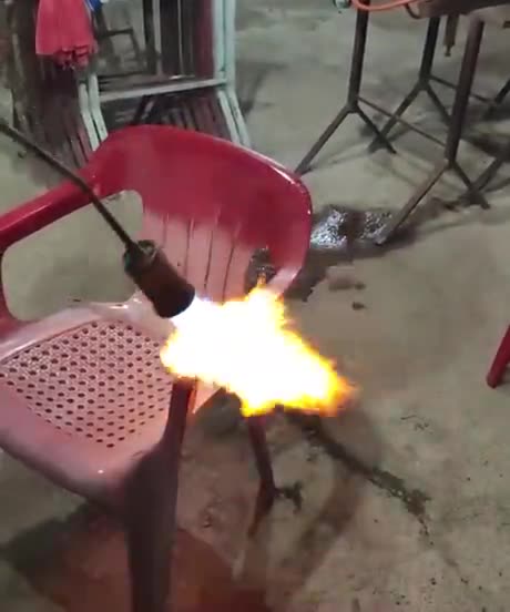 Reviving sun-faded outdoor plastic chair with a blowtorch