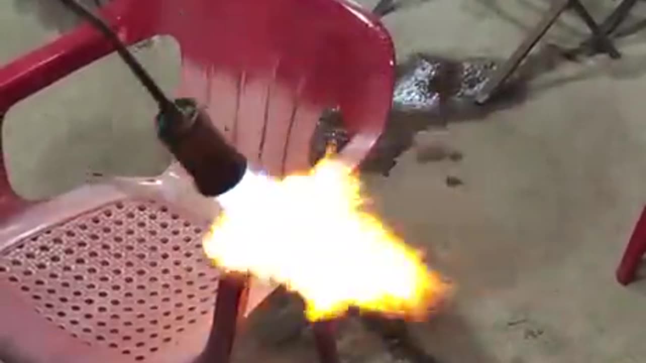 Reviving sun-faded outdoor plastic chair with a blowtorch