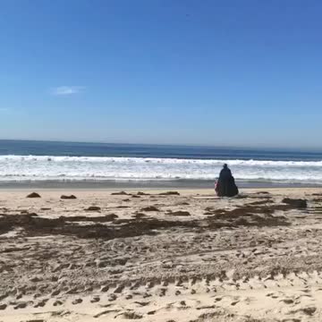 Guy black cape darthvader surf sand beach