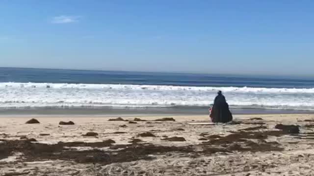 Guy black cape darthvader surf sand beach