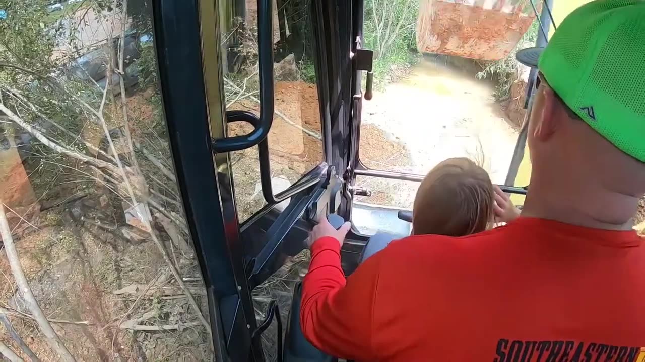 Our daughter learning to run the excavator