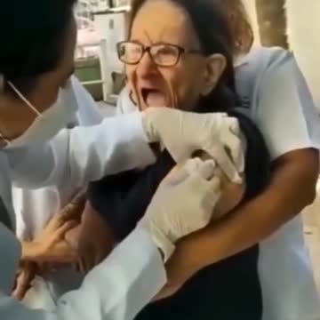 The old women is screaming while taking the vaccine